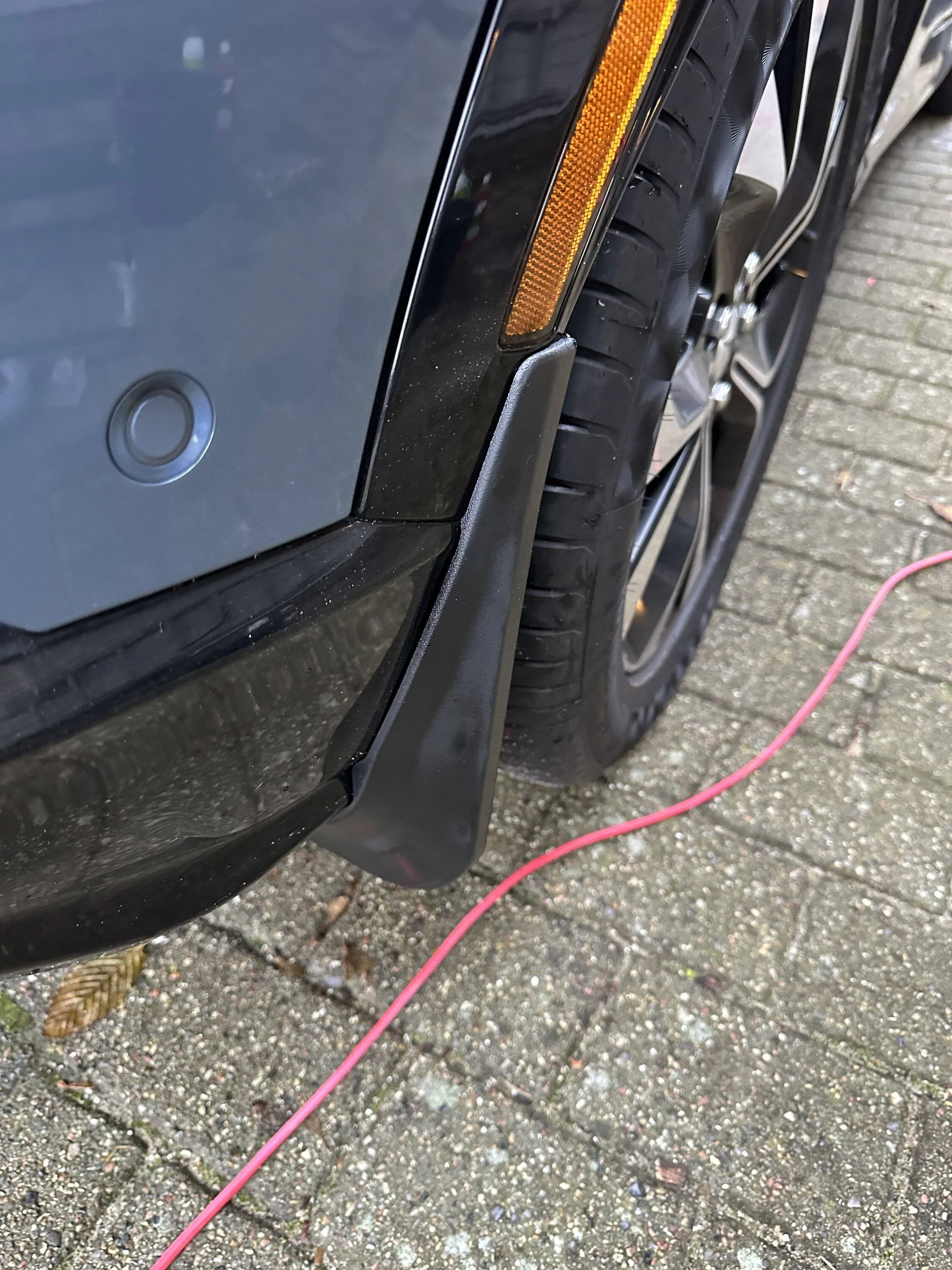 Ford Mustang Mach-E We hear that the 2023 Front Mud Flap area has changed, is it true? IMG_1166