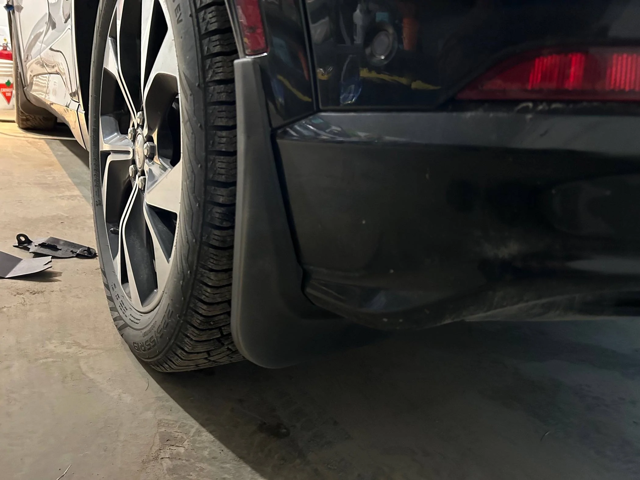 Ford Mustang Mach-E Installed Splash Guards after found OEM piece in front of rear wheel failed IMG_0431
