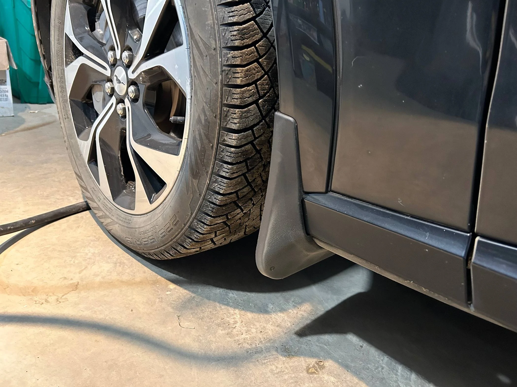 Ford Mustang Mach-E Installed Splash Guards after found OEM piece in front of rear wheel failed IMG_0430