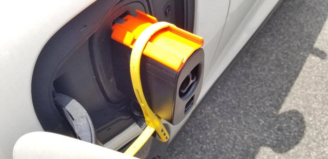 Ford Mustang Mach-E TESLA Adapter + DIY locking plate to keep it secure while plugged in. Tesla adapter and lock plate - in position - locked with lock mechanism visibl