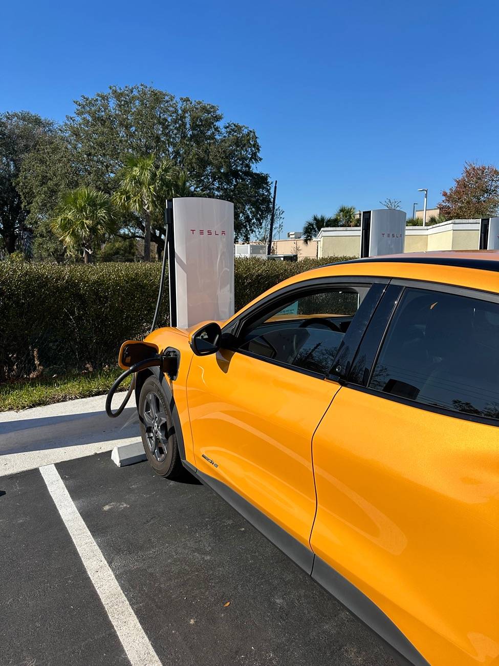 Ford Mustang Mach-E Stopped at a Tesla V4 station IMG_2758