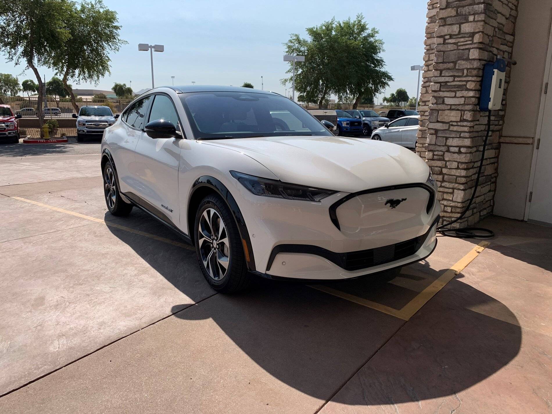 Ford Mustang Mach-E Mach-E 4x (Star White / Gray Interior) sighted at Phoenix dealership, with a look at range figures Front