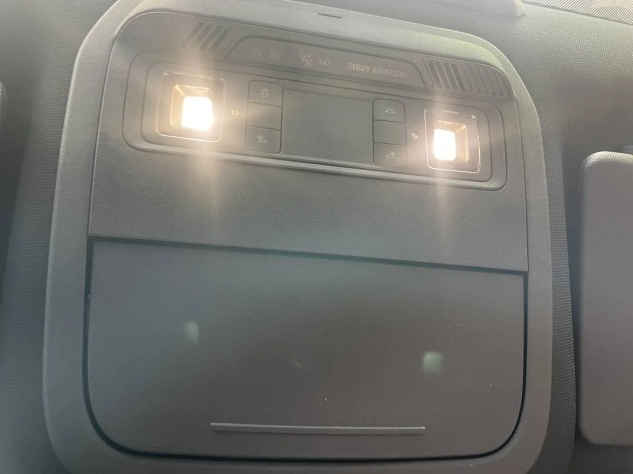 Ford Mustang Mach-E What is this red button behind a little door next to the sunglasses holder? FB1CD489-C6CC-49A1-B6B7-BA2A6F88839A